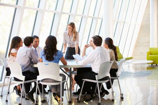 Business People Having Board Meeting In Modern Office