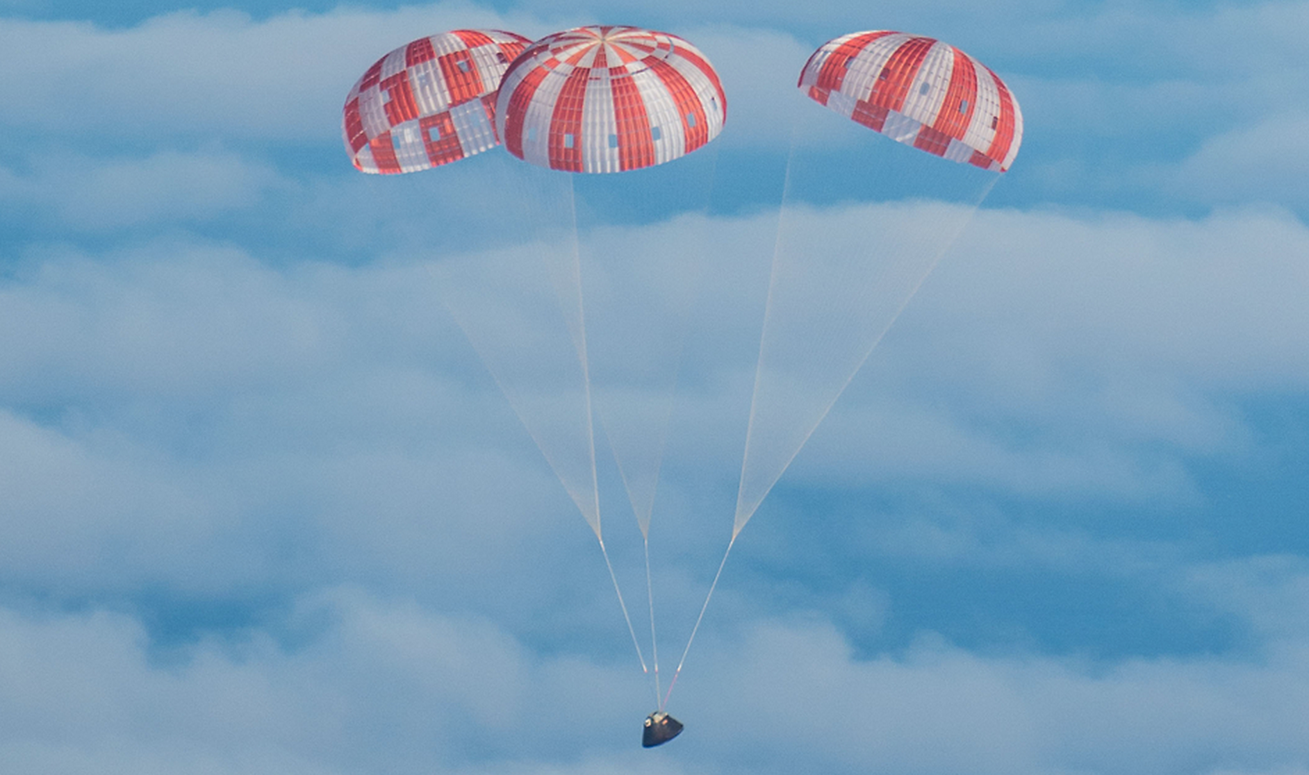 NASA’s Orion spacecraft glides through clouds