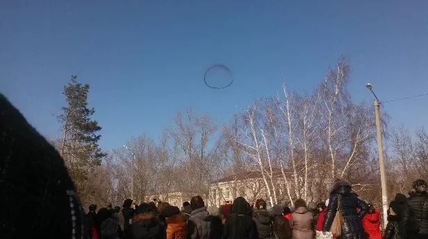 Locals watching ring in the sky