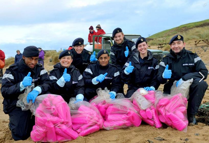 Bright pink bottles being collected by volunteers