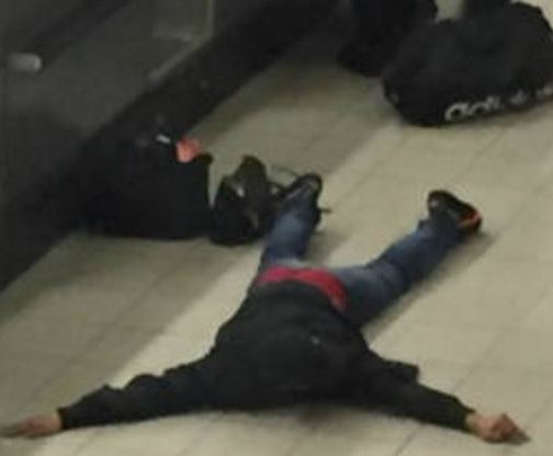 British man who shouted BOMB lying on ground with armed police