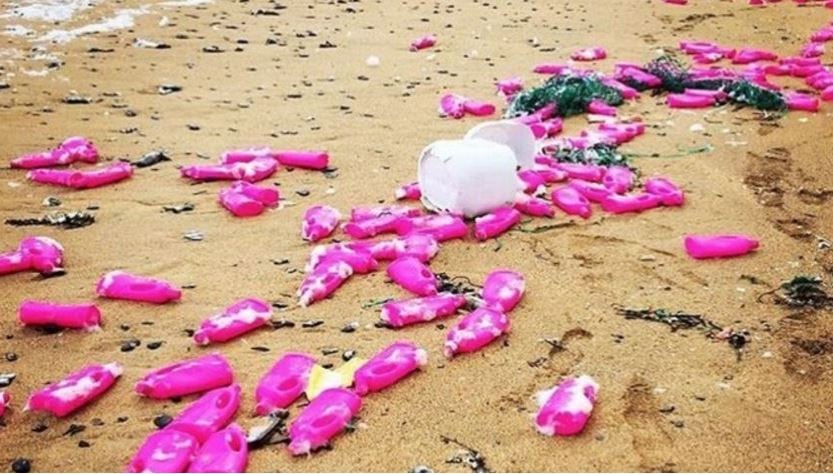Pink plastic bottles of detergent on Cornwall beaches