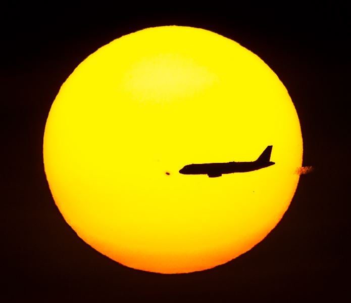 Huge Sunspot AR665 with airplane in sky