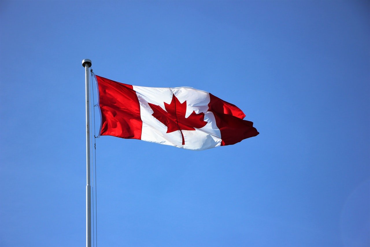 Canadian-Flag-Flying-Blue-Sky