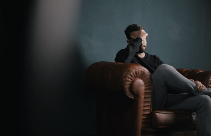 Bearded man sitting on sofa 43234