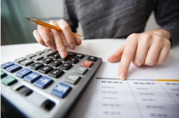 Boost your credit score - person using a calculator