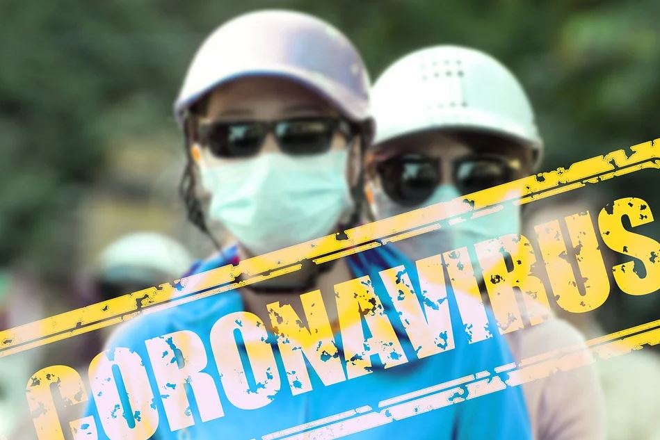 Coronavirus - image of two healthcare professionals wearing masks and helmets