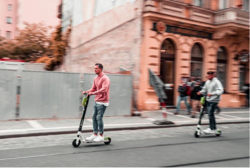 Electric scooters - image of two men scootering along a road