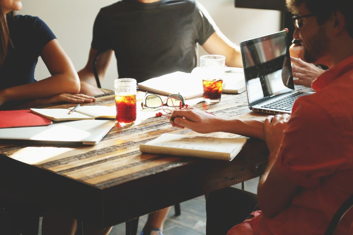 Group of office workers around a table 493