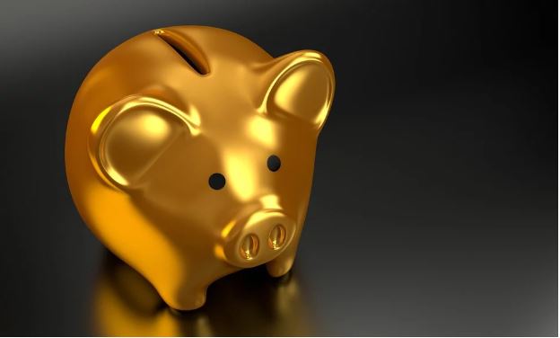 Image of a golden piggybank in a black background
