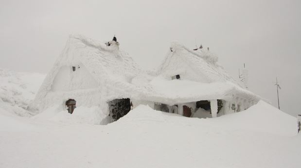 Second house covered in snow - effects of winter storm article