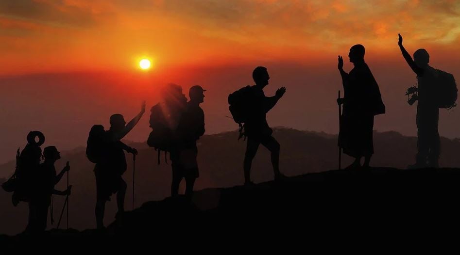 Stay fit - image showing a group of people hiking during sunser