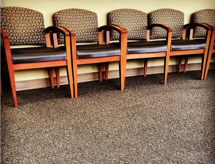 Chairs in a row on a carpet - article about flooring options