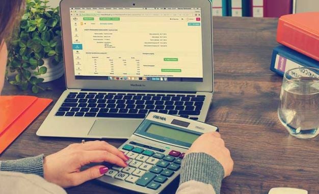 Tax software article - woman doing accounts at desk image