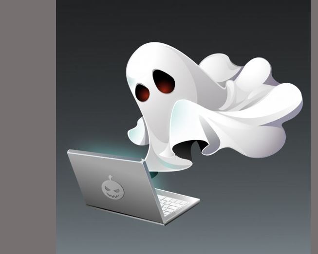 Spooky spirit in front of laptop