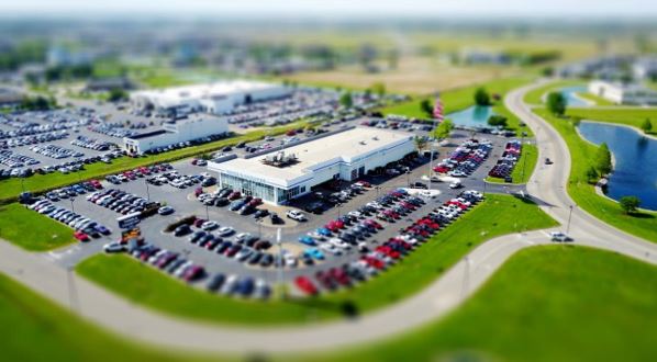 Ways for autodealerships to increase profitability - image of a car showroom and outside it