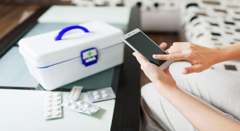 Using smartphone next to first aid box