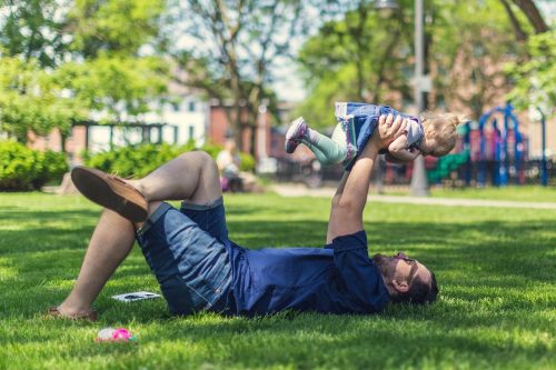 father with baby as example of parental leave perk