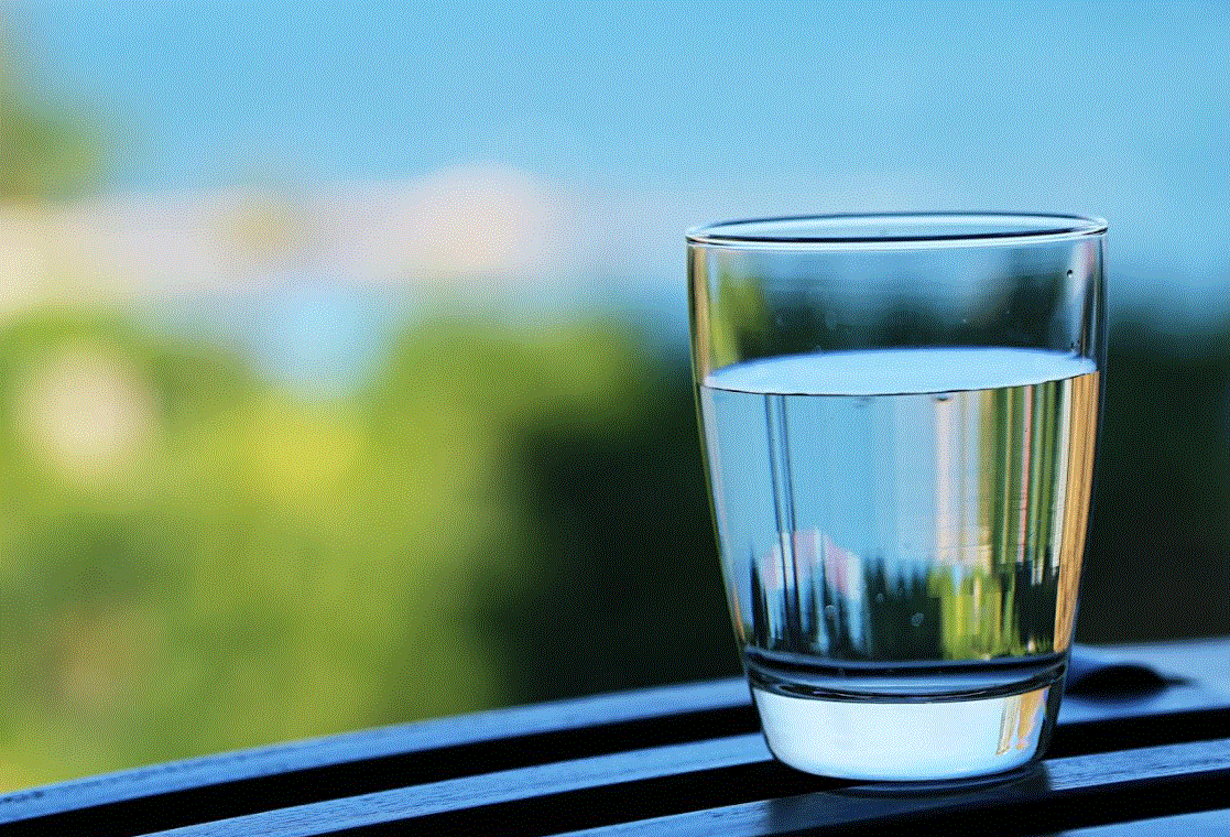 Drink hydrogen water - a glass of water on the window sill
