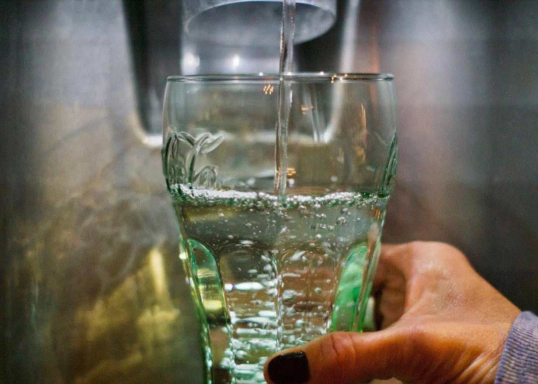 Drink hydrogen water - image of woman holding a glass of water