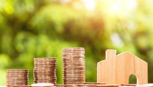 coin stacks with wooden house model