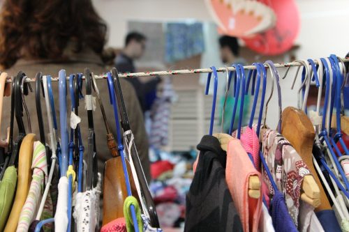 secondhand clothes on rail in thrift store