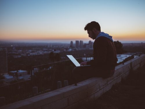 agile worker using laptop on roof