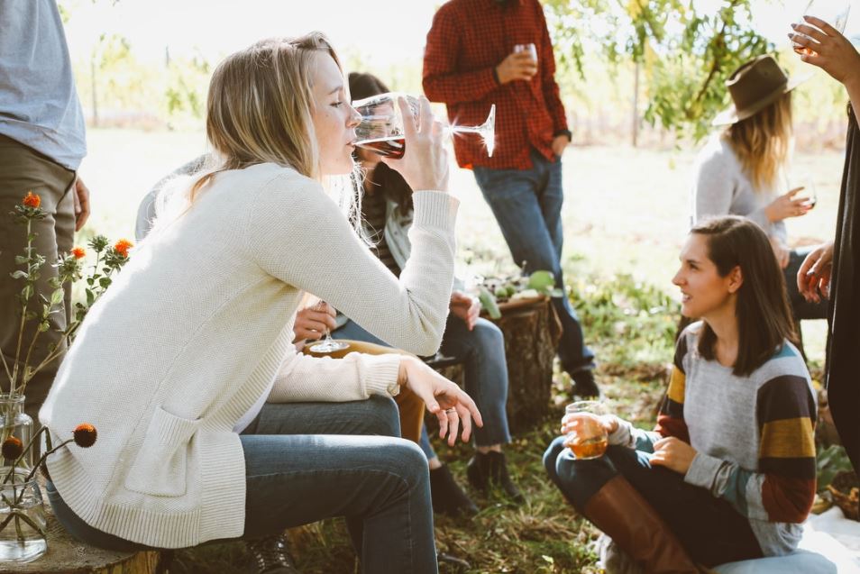 Adults outdoors having drinks - a589389383