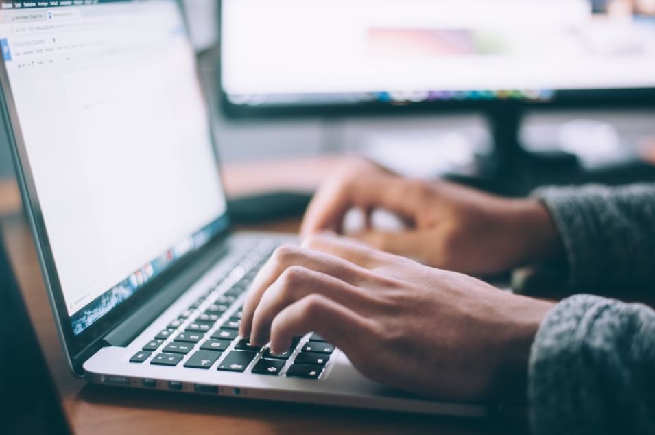 Male hands typing on Laptop keyboard - artcle about first time home buyers