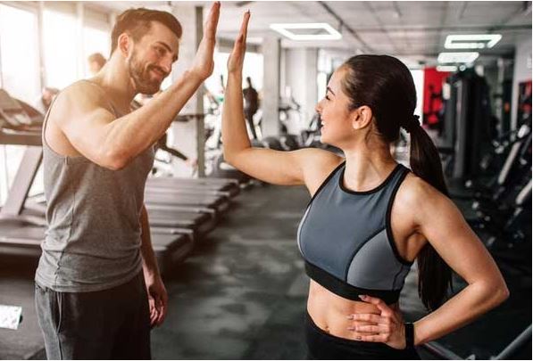 Man and woman high five in the gym - For Non stimulant fat burners article