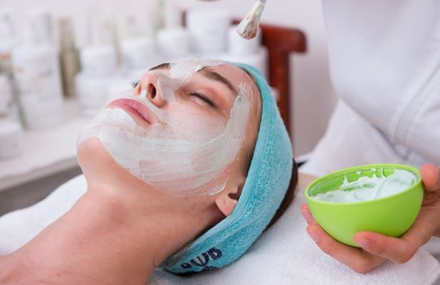 Lady with cream being applied to her face