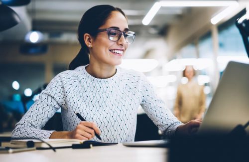 Women at desk working - boost employee morale