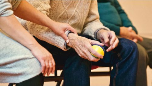 Holding arm of elderly person