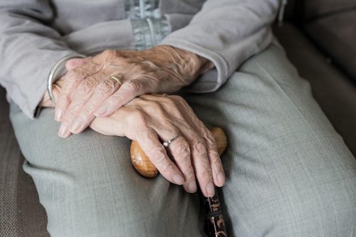 Old man holding walking stick