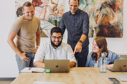 A picture of a group of happy employees treated well like Elijah Norton suggests.