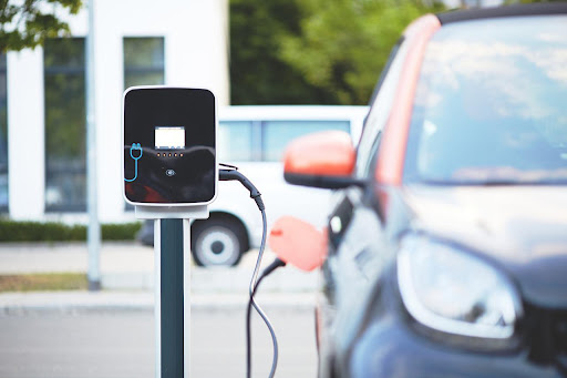 A picture of a parked electric car chagrin at a station.