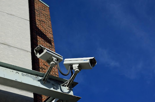 Photo of two CCTV security cameras installed outside a building.