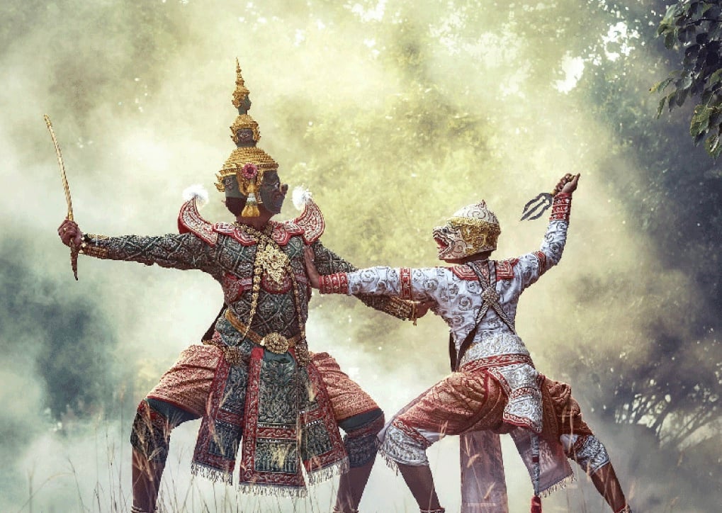  An illustration of two masked dancers in traditional Thai costumes performing the Khon, a masked dance-drama that depicts stories from the Ramakien, the Thai version of the Hindu epic Ramayana, which is an important part of Thai cultural identity and historical heritage.
