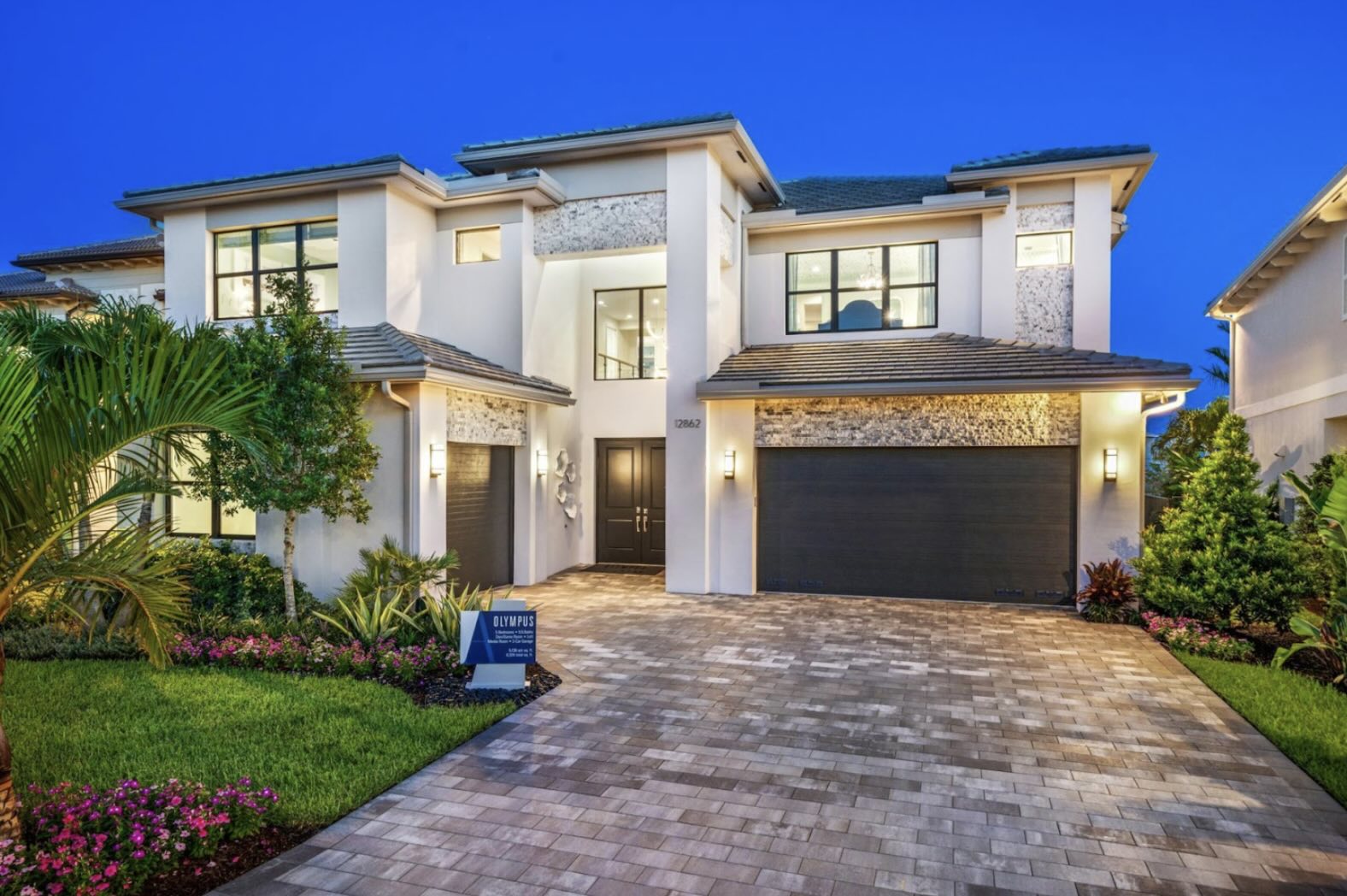 Luxurious modern home design by Misha and Itchko Ezratti's GL Homes at Apex Avenir in Palm Beach Gardens, Florida, showcasing elegant architecture and lush landscaping