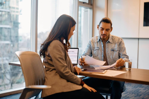 A male entrepreneur reviewing different loans for new businesses.