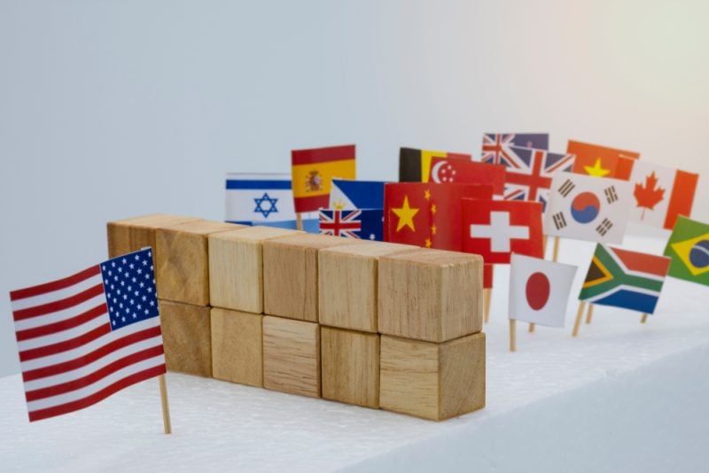 US Flag with wooden blocks dividng it between other world flags