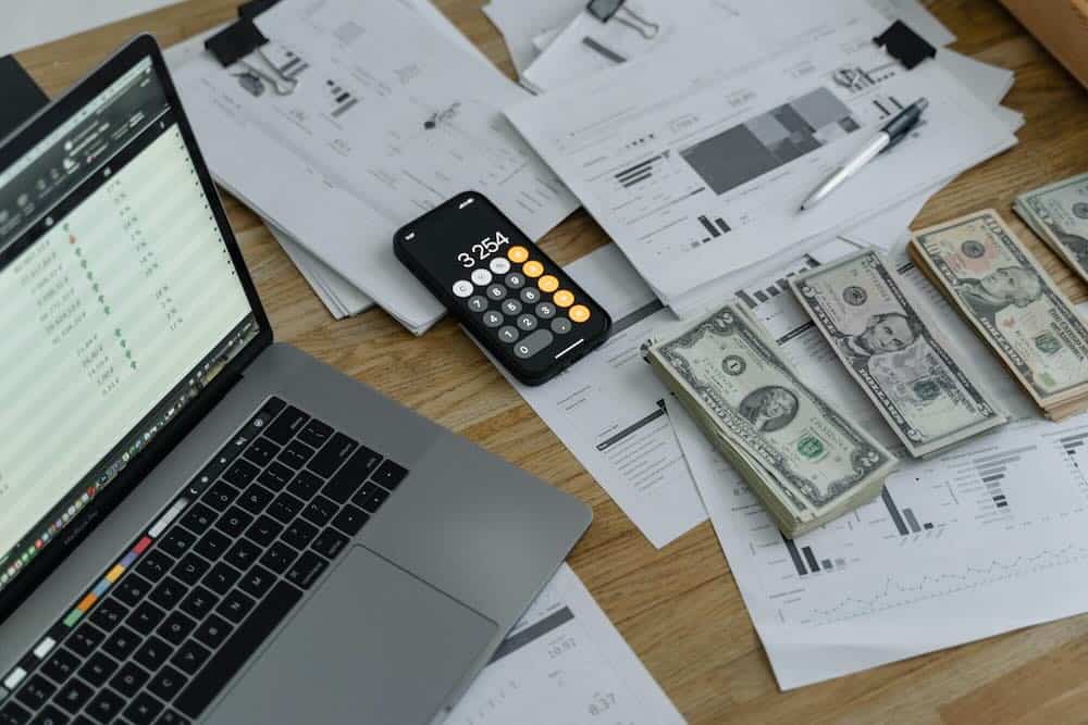 calculating-earnings-laptop-graphs-desk