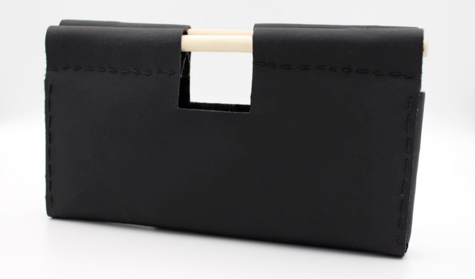 Prototype of an accessory bag prepared from mycelium-based nonwoven with textile backing and a wooden handle. Image credit: Ahokas et al., ACS Applied Bio Materials, 2026, CC BY 4.0.