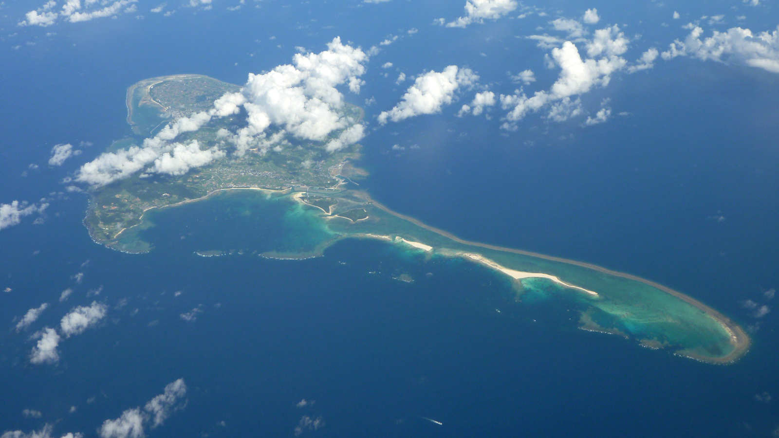 Aerial view of Kume Island and its surrounding reefs in Okinawa, Japan. Source photograph: “Kumejima.jpg” by Paipateroma, Wikimedia Commons. License: Creative Commons Attribution 3.0 Unported (CC BY 3.0).