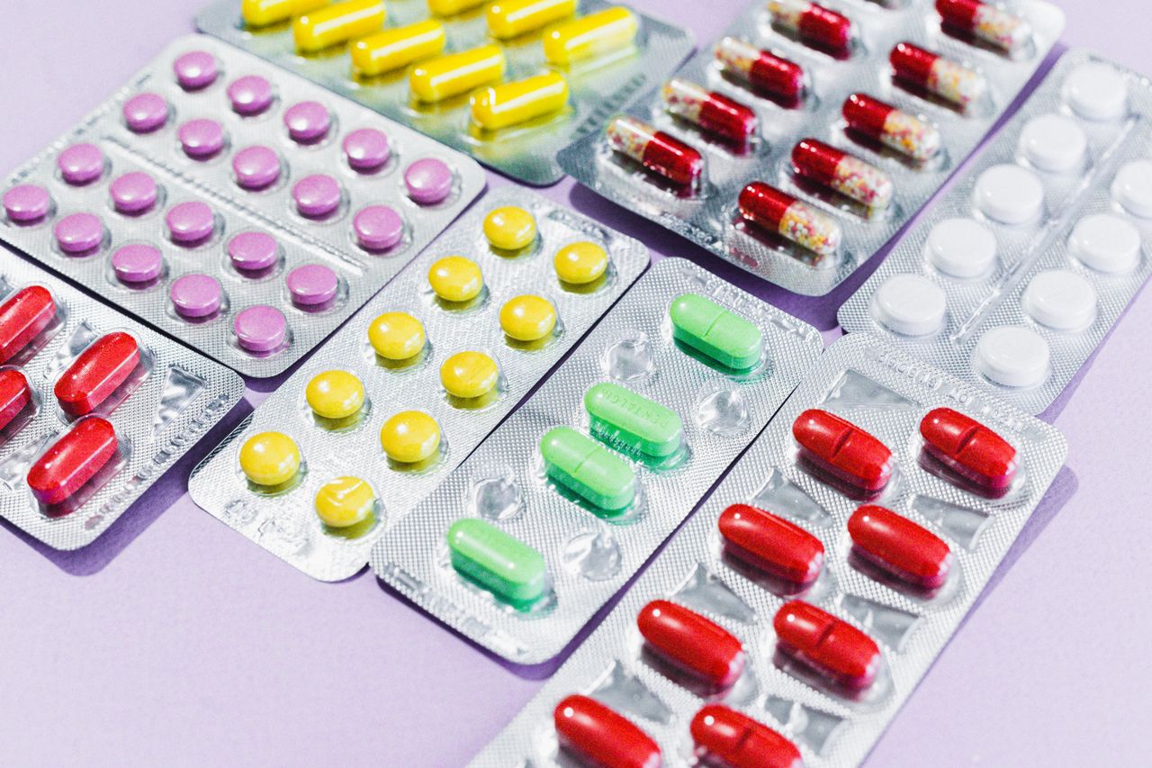 Close-up of various colorful pills in blister packs, showcasing diverse medicine type