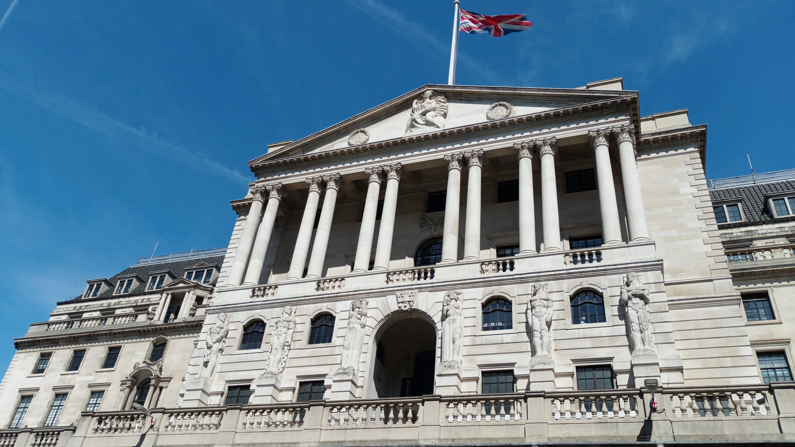 Exterior of the Bank of England in London under a restrained navy editorial grade.