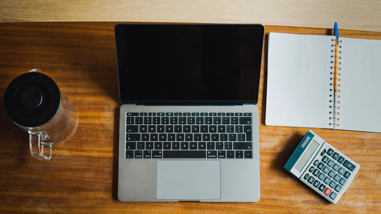 A laptop and calculator on an office desk. Representative photograph, not an approved French invoicing platform