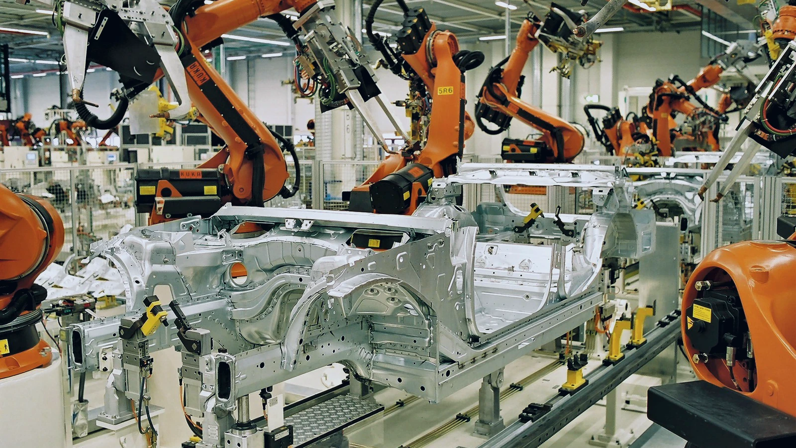 Archive photograph of industrial robots welding car bodies at a German factory.