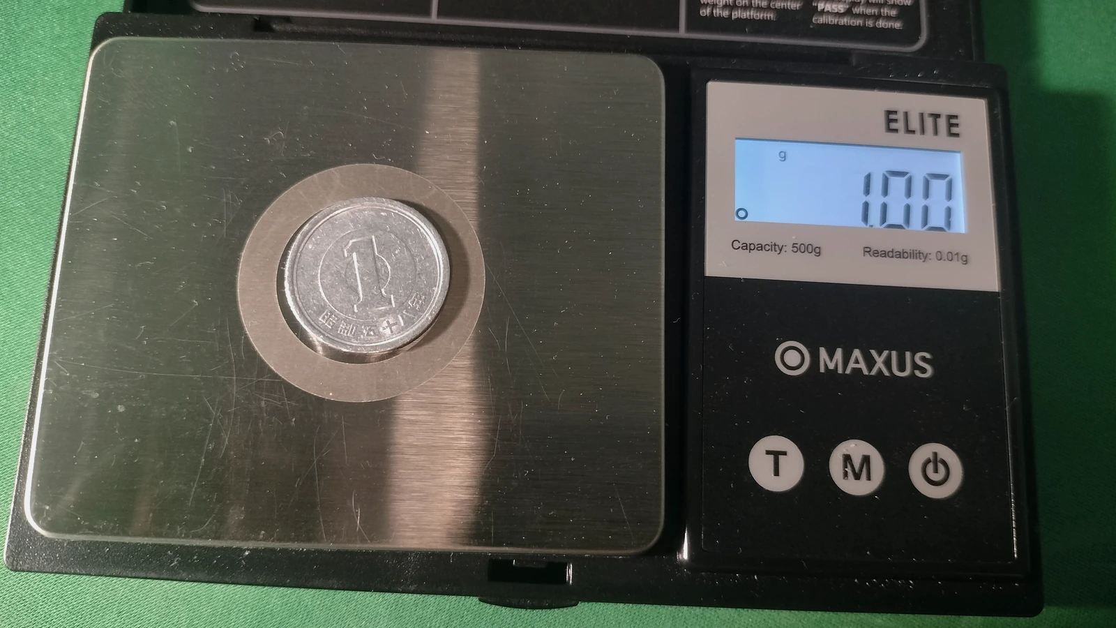 A Japanese one-yen coin resting on a digital scale, shown as a representative image.