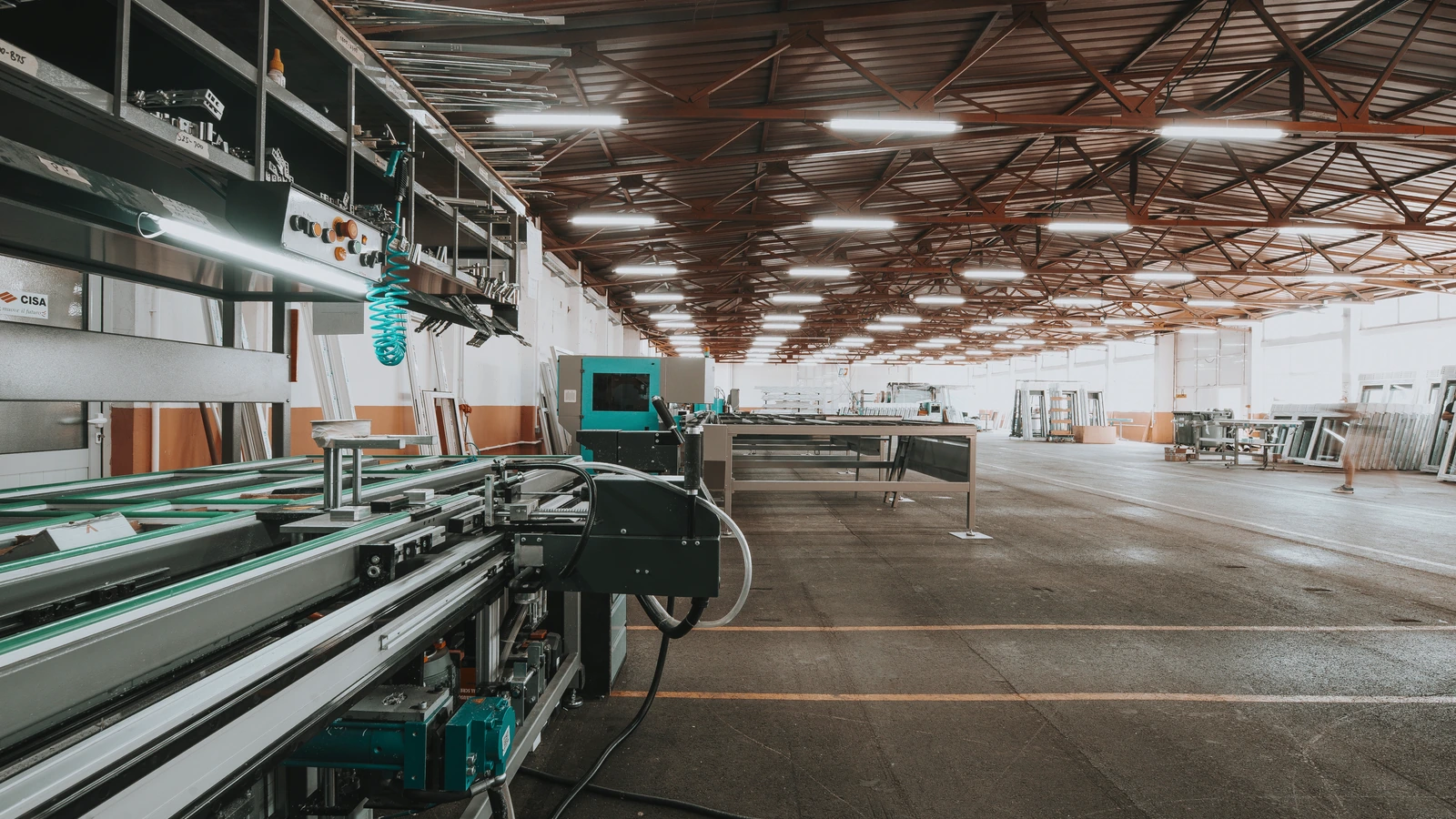 A modern factory production line and machinery inside a large industrial building.